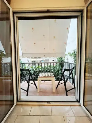 a patio with a table and chairs on a balcony at TCG Ithakis in Athens