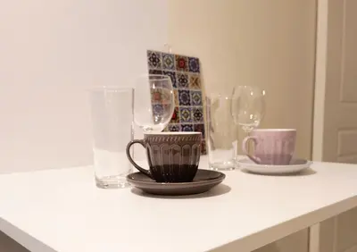 a counter with wine glasses and plates on it at TCG Ithakis in Athens