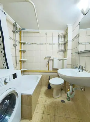 a bathroom with a washing machine and a sink at TCG Ithakis in Athens
