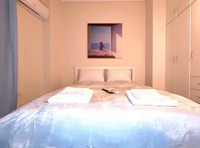 a bedroom with a bed with two towels on it at TCG Ithakis in Athens