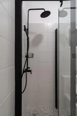 a shower with a glass door in a bathroom at Kipseli Secret Heaven in Athens