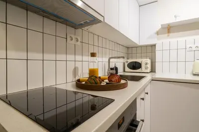 a kitchen with a bowl of fruit on a counter at Kipseli Secret Heaven in Athens