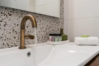 a sink with a faucet on a white counter at Kipseli Secret Heaven in Athens