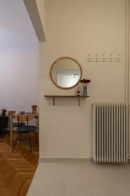 a room with a mirror and a radiator and a table at Kipseli Secret Heaven in Athens