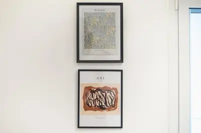 four framed prints of art on a wall at City Vibes Stylish 2BR and a Stunning Balcony in Athens