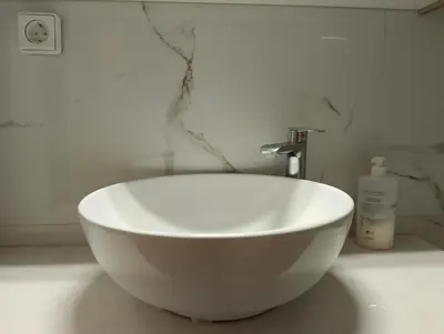 a white bowl sink sitting on a counter in a bathroom at Patisia Metro Station 2 bdrm apartment by MPS in Athens