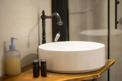 a sink with a faucet and a bottle of soap at Dream Apt in Ampelokipoi in Athens
