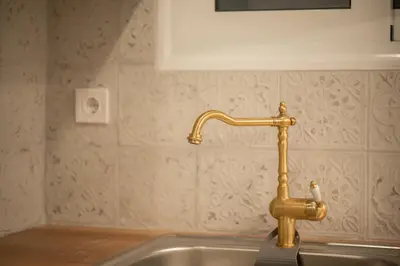 a kitchen sink with a gold faucet at Dream Apt in Ampelokipoi in Athens