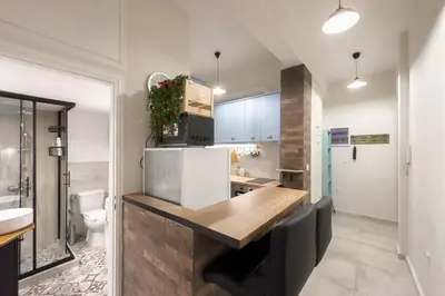 a kitchen with a counter with a sink and a toilet at Dream Apt in Ampelokipoi in Athens