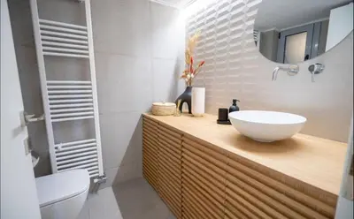 a bathroom with a sink and a toilet and a mirror at Apartment with Sea View Piraeus 4 people in Piraeus