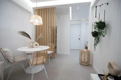a dining room with a white table and chairs at Apartment with Sea View Piraeus 4 people in Piraeus