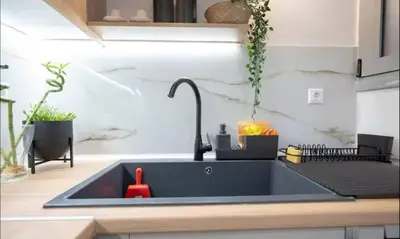 a kitchen sink with a red faucet at Apartment with Sea View Piraeus 4 people in Piraeus