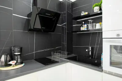 a black and white kitchen with a microwave at Arion in Athens