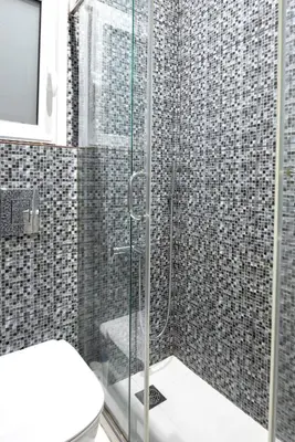 a bathroom with a shower with a toilet and a television at Arion in Athens