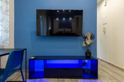 a blue wall with a table and a blue cabinet at EstelZan Apartment in Athens
