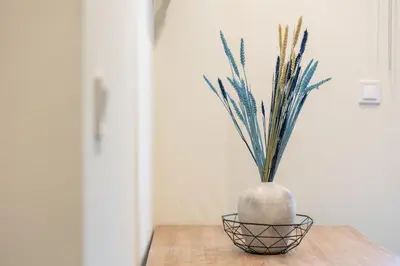 a vase with a plant sitting on a table at EstelZan Apartment in Athens
