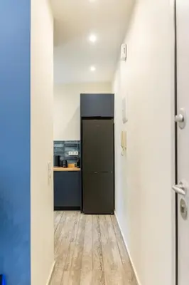 a hallway with a door leading to a kitchen at EstelZan Apartment in Athens