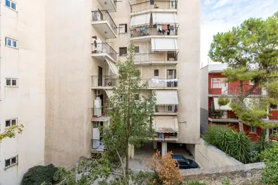 an apartment building with people on the balconies at EstelZan Apartment in Athens