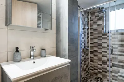 a bathroom with a sink and a shower at EstelZan Apartment in Athens