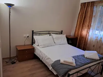 a bedroom with a bed with two towels on it at West Athens Welcome Δυτικά της Αθήνας in Athens