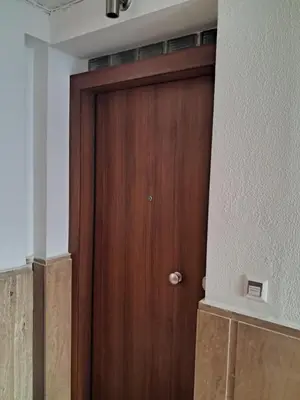 a wooden door in the corner of a room at West Athens Welcome Δυτικά της Αθήνας in Athens