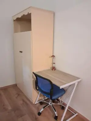 a desk with a blue chair next to a door at West Athens Welcome Δυτικά της Αθήνας in Athens