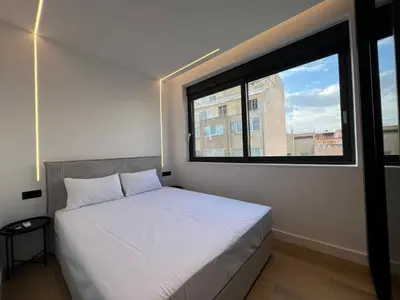 a bed in a room with a large window at BlueMotion - CruiseNest Complex in Piraeus