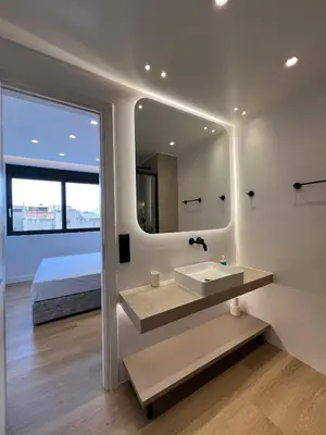 a bathroom with a sink and a mirror at BlueMotion - CruiseNest Complex in Piraeus