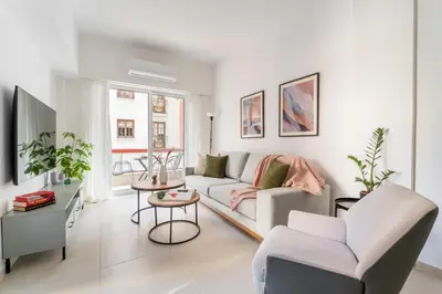 a white living room with a couch and a table at Secret Central Gem Near Kolonaki in Athens