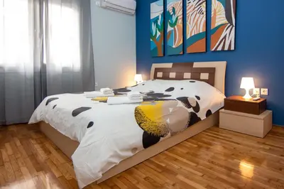 a bedroom with a bed with a cow comforter at Nice Apartment in Athens center in Athens