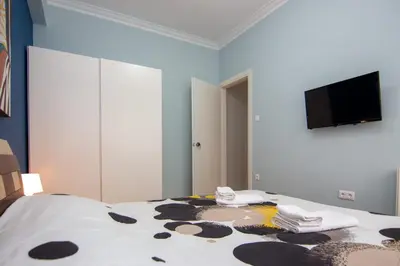 a bedroom with a bed and a flat screen tv at Nice Apartment in Athens center in Athens