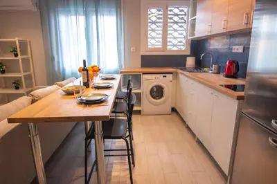 a kitchen with a table and a washing machine at Nice Apartment in Athens center in Athens