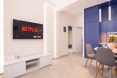 a living room with a tv on a wall at Apartment near Onassis cultural center in Athens