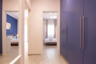 a room with purple doors and a room with a bedroom at Apartment near Onassis cultural center in Athens