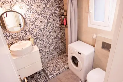 a bathroom with a sink and a washing machine at Apartment near Onassis cultural center in Athens