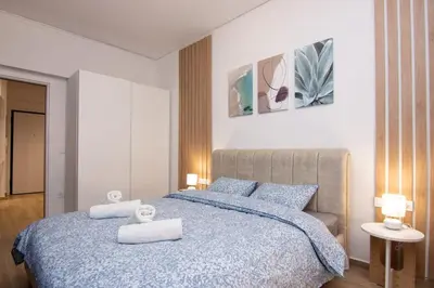 a bedroom with a blue bed with towels on it at Sweet 2 bedroom apartment in Greek colors in Athens