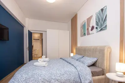 a bedroom with a bed with a teddy bear on it at Sweet 2 bedroom apartment in Greek colors in Athens