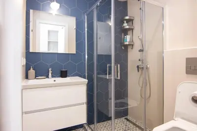 a bathroom with a shower and a sink and a toilet at Sweet 2 bedroom apartment in Greek colors in Athens