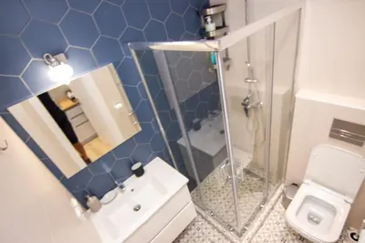 a bathroom with a toilet and a sink and a mirror at Sweet 2 bedroom apartment in Greek colors in Athens