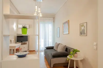 a living room with a couch and a table at Work of Art Athens in Athens