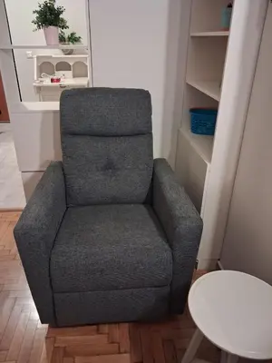 a gray chair in a room with a table at Work of Art Athens in Athens
