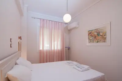 a white room with a bed and a window at Work of Art Athens in Athens