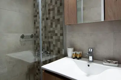 a bathroom with a sink and a shower at Work of Art Athens in Athens