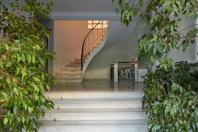a staircase in a house with green plants at Athens Acropolis Residence, by the Acropolis Museum in Athens