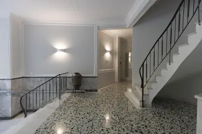 a hallway with a staircase and a floor with a tile floor at Athens Acropolis Residence, by the Acropolis Museum in Athens