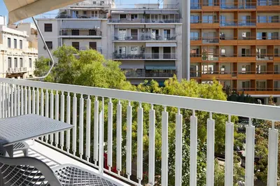 a balcony with a table and a building at Athens Acropolis Residence, by the Acropolis Museum in Athens