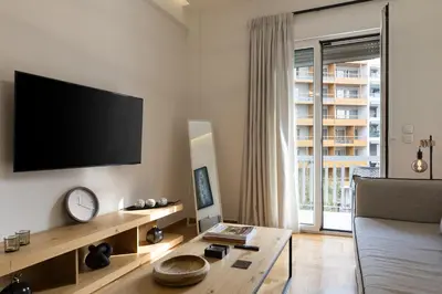 a living room with a flat screen tv on a wall at Athens Acropolis Residence, by the Acropolis Museum in Athens