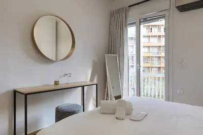 a bedroom with a bed and a mirror and a window at Athens Acropolis Residence, by the Acropolis Museum in Athens