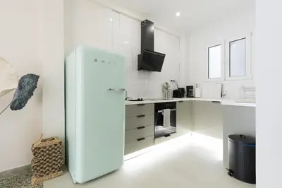 a white kitchen with a refrigerator in a room at Athens Acropolis Residence, by the Acropolis Museum in Athens