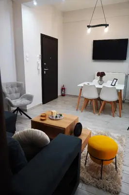 a living room with a couch and a table at Athenian Petralona Suite near Athens City centre in Athens
